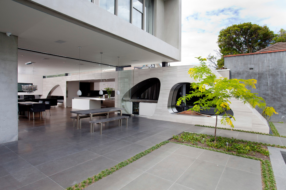 Inspiration for a contemporary kitchen in Melbourne with light wood cabinets, quartz benchtops, metallic splashback and glass sheet splashback.