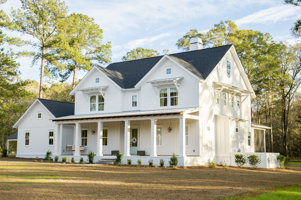 Photo of a country two-storey white house exterior in Atlanta with wood siding, a gable roof and a shingle roof.