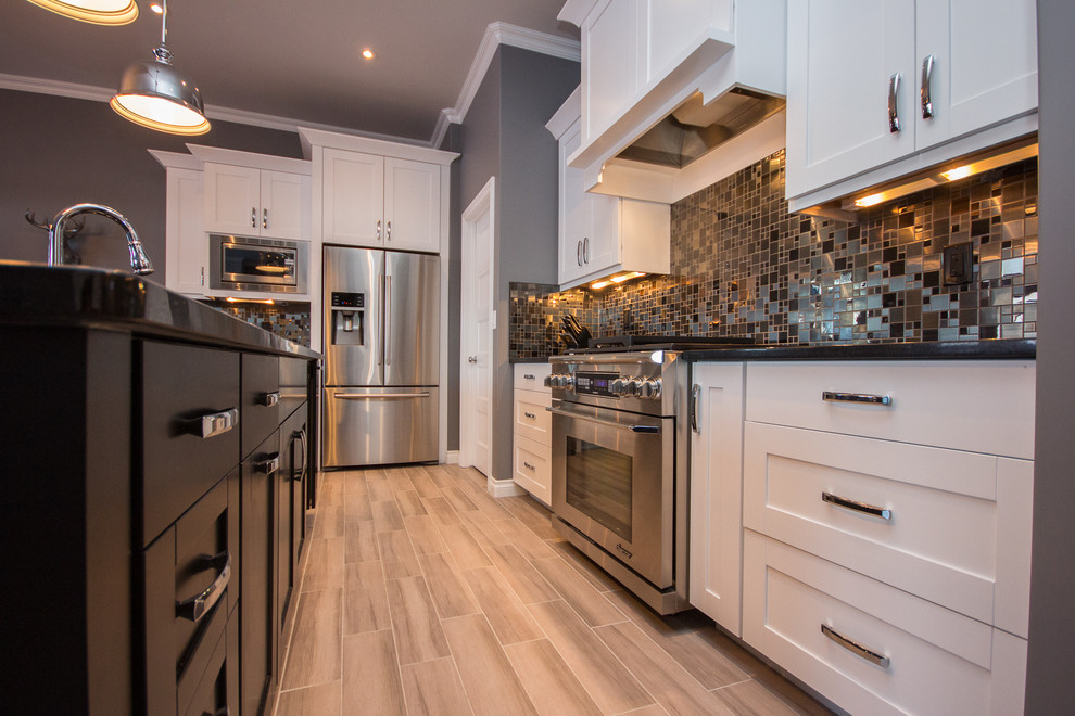Mid-sized transitional l-shaped porcelain tile eat-in kitchen photo in Calgary with a double-bowl sink, shaker cabinets, white cabinets, multicolored backsplash, mosaic tile backsplash, stainless steel appliances, an island and quartz countertops