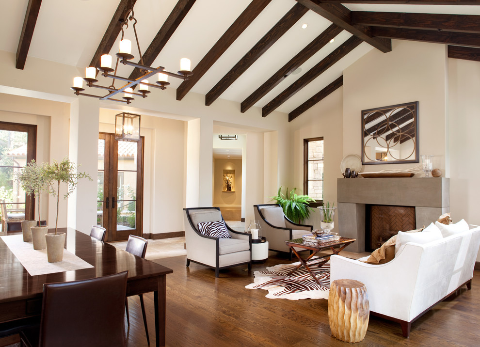 Inspiration for a large mediterranean formal open concept living room in San Francisco with beige walls, dark hardwood floors, a standard fireplace, a stone fireplace surround and no tv.