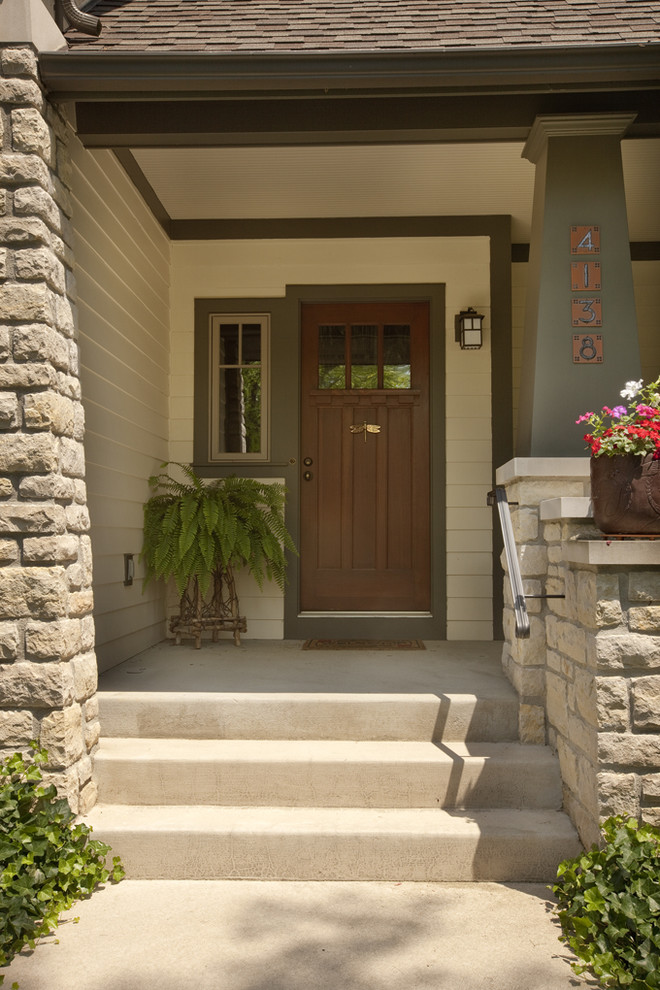 Arts and crafts front door in Columbus with a single front door and a dark wood front door.