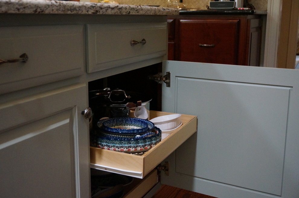 Large transitional u-shaped eat-in kitchen photo with raised-panel cabinets, granite countertops and an island