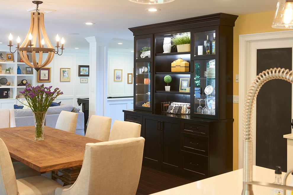 Mid-sized transitional kitchen/dining combo in New York with yellow walls, dark hardwood floors and no fireplace.