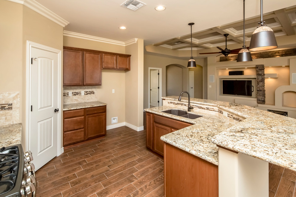 Eat-in kitchen - mid-sized transitional u-shaped porcelain tile eat-in kitchen idea in Phoenix with an undermount sink, flat-panel cabinets, medium tone wood cabinets, granite countertops, beige backsplash, mosaic tile backsplash, stainless steel appliances and no island