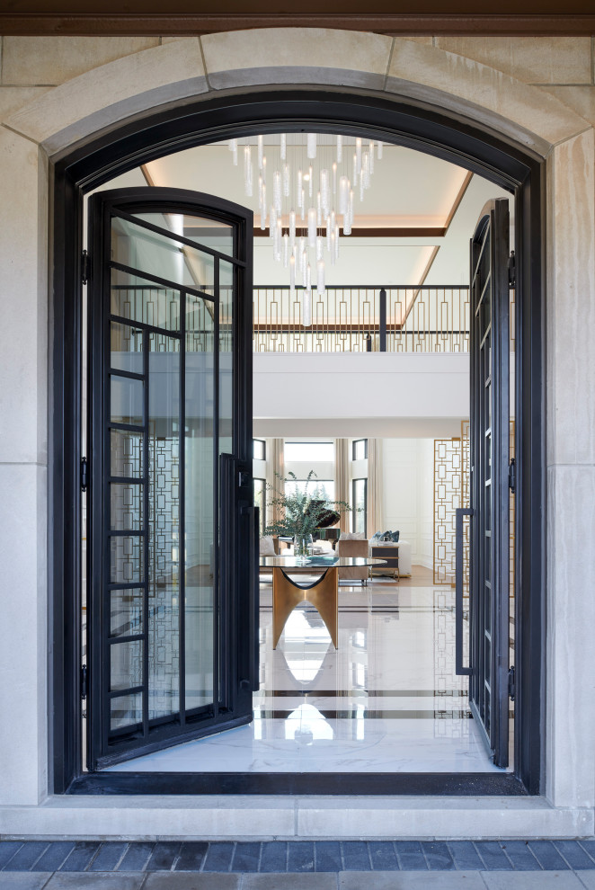 Photo of an expansive transitional foyer in Detroit with white walls, porcelain floors, a double front door, a black front door, white floor and panelled walls.