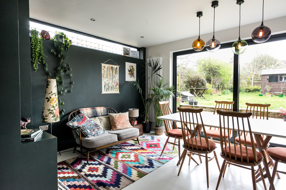 Design ideas for a mid-sized eclectic open plan dining in London with concrete floors and white floor.