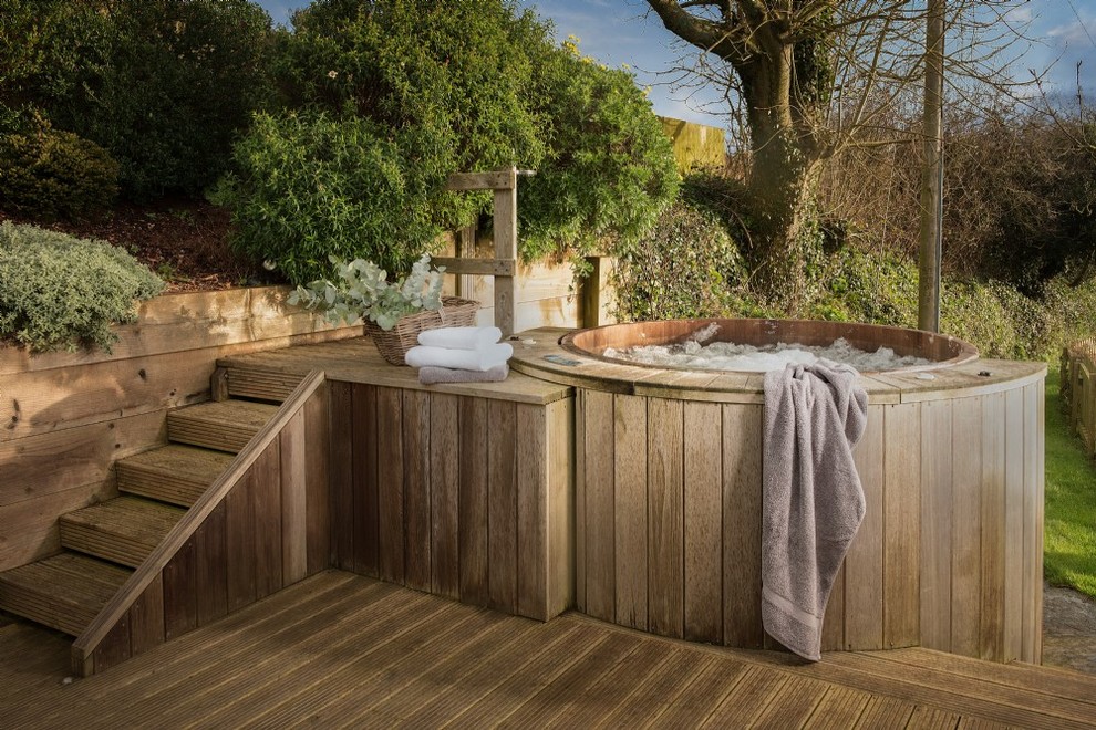 Inspiration for a mid-sized country backyard aboveground pool in Devon with a hot tub.