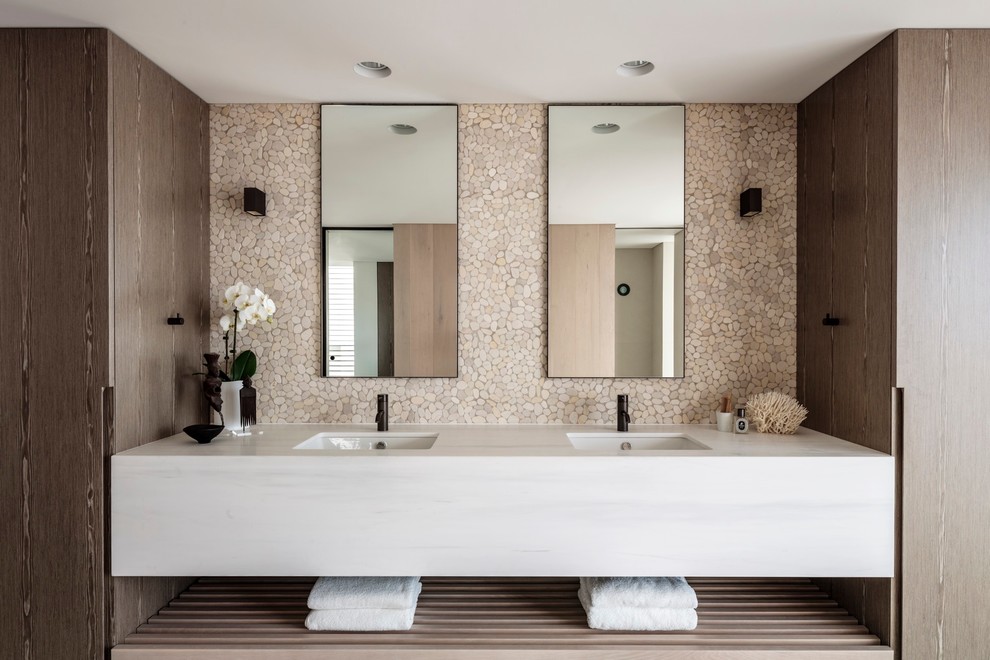 Contemporary master bathroom in Sydney with white cabinets, beige tile, beige walls, ceramic floors, an undermount sink and marble benchtops.