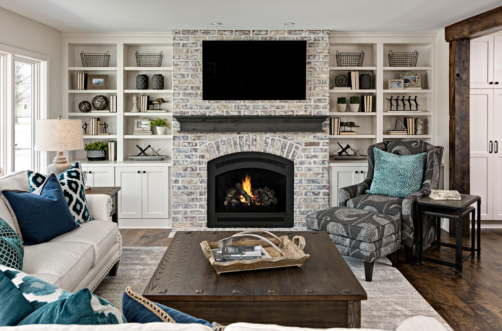 Mid-sized transitional open concept living room in Minneapolis with grey walls, dark hardwood floors, a standard fireplace, a brick fireplace surround, a wall-mounted tv and brown floor.
