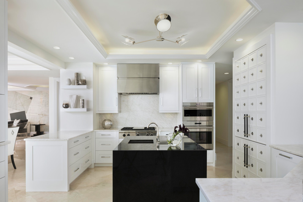 Inspiration for a transitional kitchen remodel in Miami with white cabinets, white backsplash, stainless steel appliances and an island