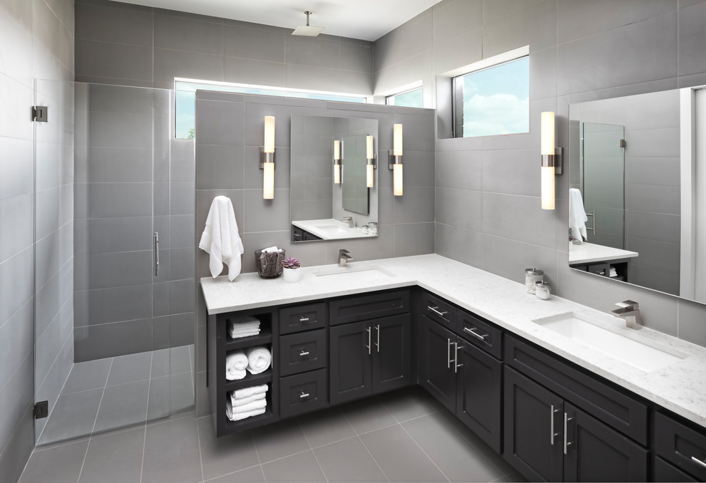 This is an example of a mid-sized transitional master bathroom in Dallas with shaker cabinets, black cabinets, a curbless shower, gray tile, ceramic tile, grey walls, ceramic floors, an undermount sink, engineered quartz benchtops, grey floor and a hinged shower door.