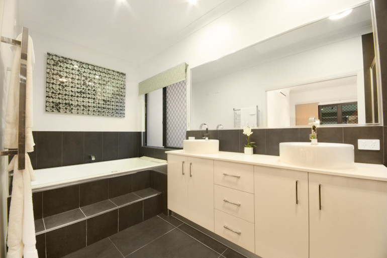 Mid-sized contemporary master bathroom in Cairns with a drop-in tub, a corner shower, gray tile, ceramic tile and white walls.