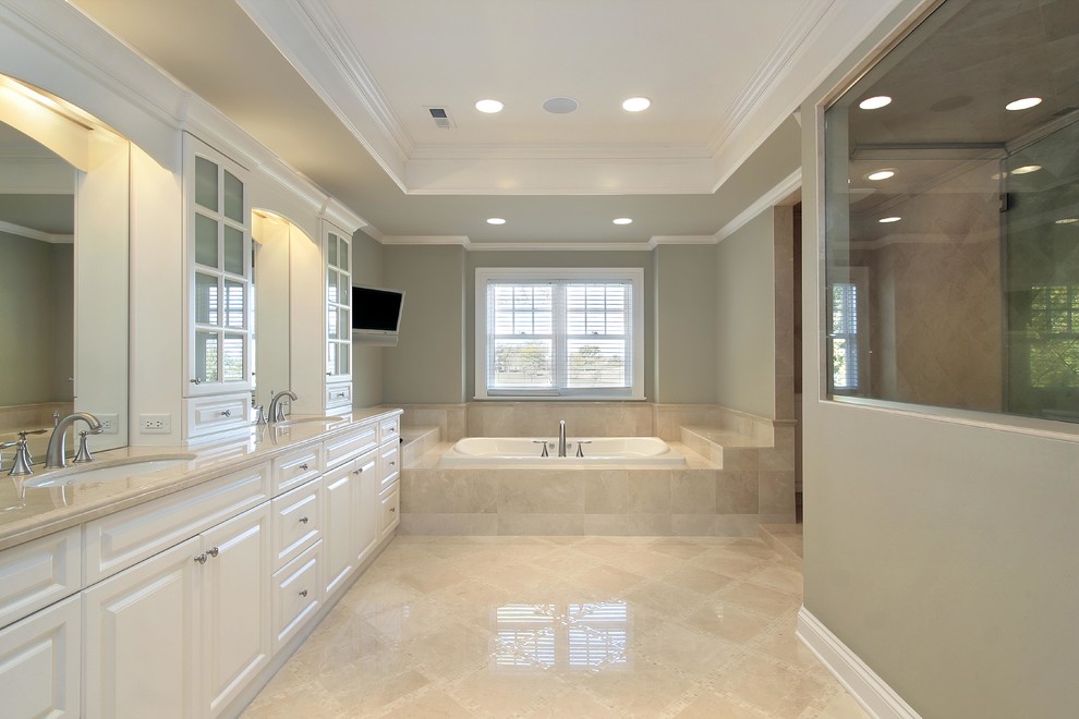 Design ideas for a large traditional master bathroom in San Francisco with furniture-like cabinets, white cabinets, a hot tub, a corner shower, a one-piece toilet, grey walls, vinyl floors, an undermount sink, wood benchtops, beige floor, a hinged shower door and beige benchtops.