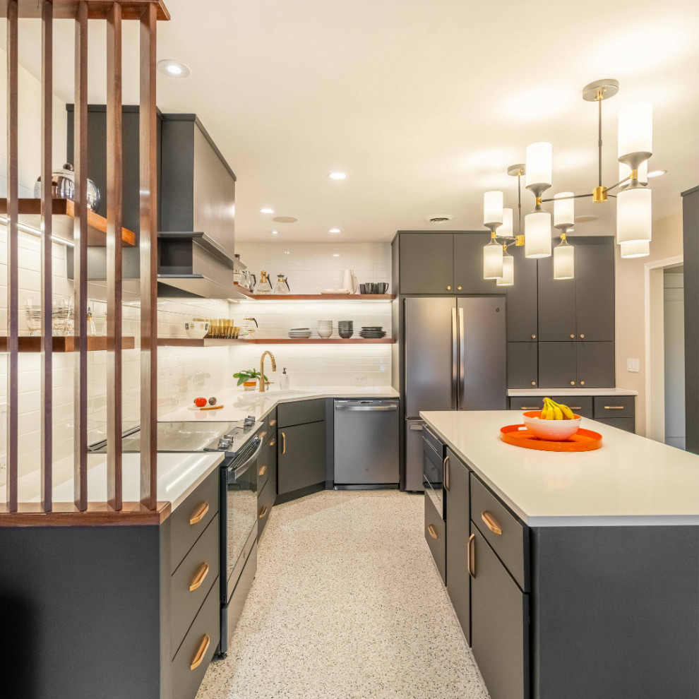 Photo of a large modern l-shaped enclosed kitchen in Minneapolis with a submerged sink, flat-panel cabinets, black cabinets, engineered stone countertops, white splashback, ceramic splashback, stainless steel appliances, laminate floors, an island, white floors and white worktops.