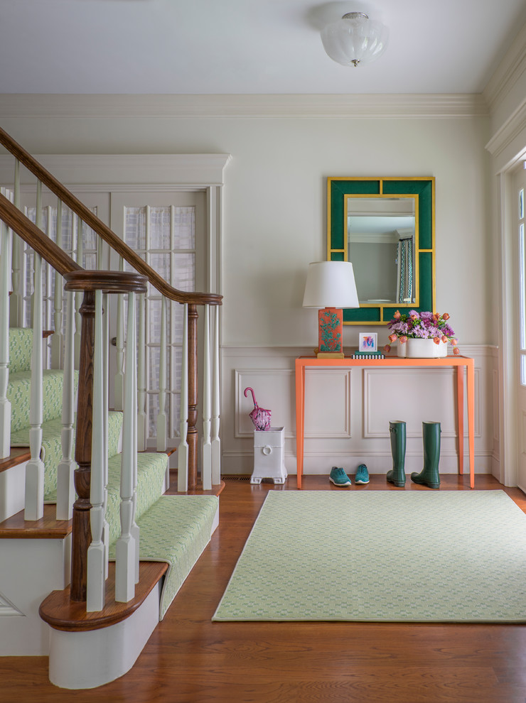 Mid-sized transitional foyer in Boston with white walls, medium hardwood floors, brown floor and a white front door.