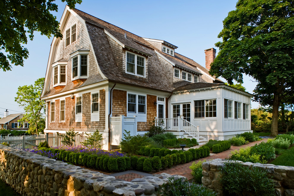 Inspiration for a large traditional three-storey exterior in Providence with a gambrel roof.