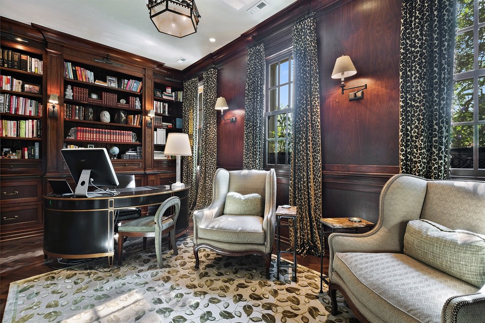 This is an example of a traditional study room in Chicago with dark hardwood floors, no fireplace and a freestanding desk.
