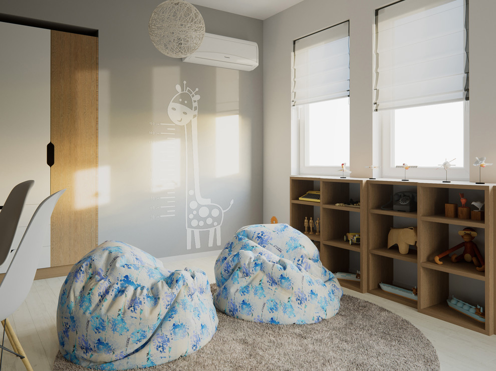 Photo of a mid-sized scandinavian kids' room for boys in London with white walls and light hardwood floors.