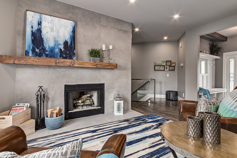 Design ideas for an expansive transitional open concept living room in Calgary with grey walls, dark hardwood floors and a standard fireplace.