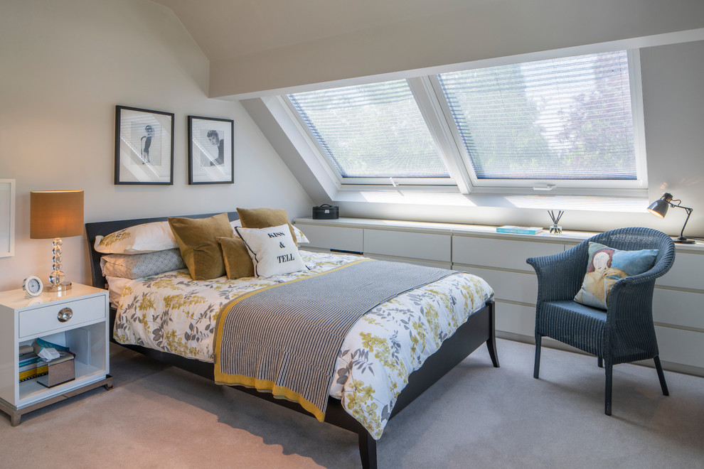 This is an example of a mid-sized contemporary guest bedroom in Surrey with white walls, carpet, beige floor and no fireplace.