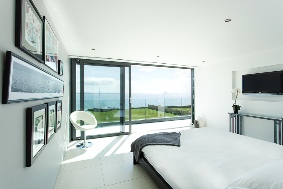 Contemporary bedroom in Hampshire with white walls and white floor.