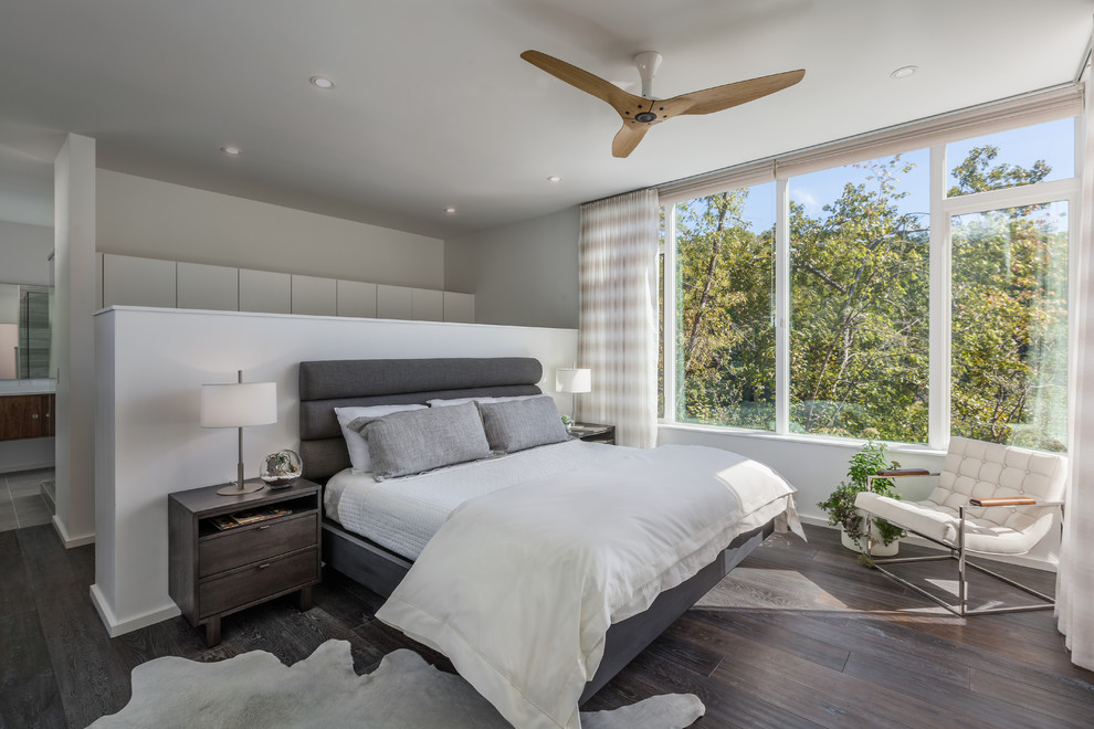 Mid-sized contemporary master bedroom in Charleston with white walls and dark hardwood floors.