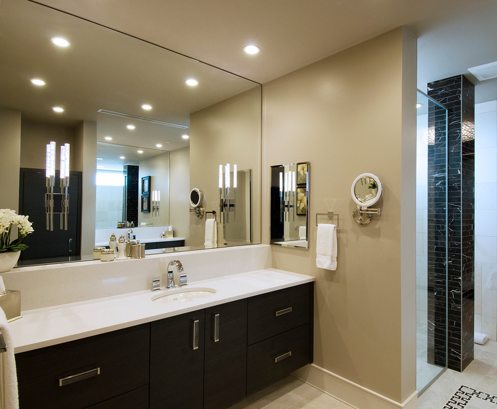 This is an example of a large transitional master bathroom in Denver with an undermount sink, flat-panel cabinets, dark wood cabinets, solid surface benchtops, an open shower, a one-piece toilet, beige tile, porcelain tile, grey walls and mosaic tile floors.