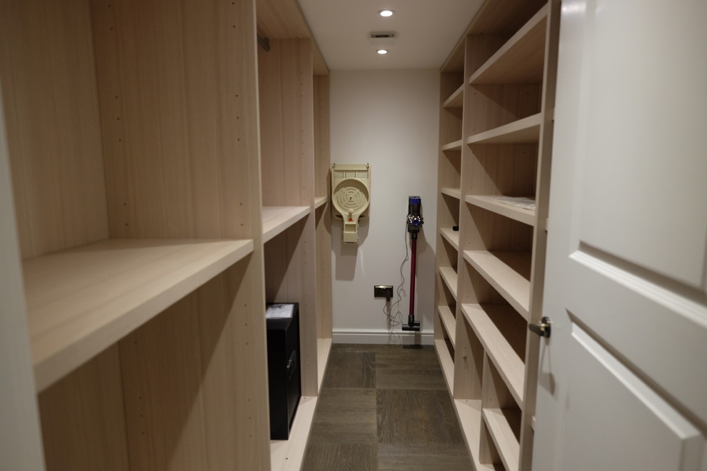 This is an example of a traditional storage and wardrobe in London with open cabinets.