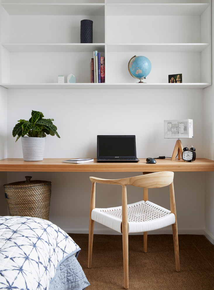 Design ideas for a mid-sized scandinavian home office in Melbourne with white walls, carpet and no fireplace.