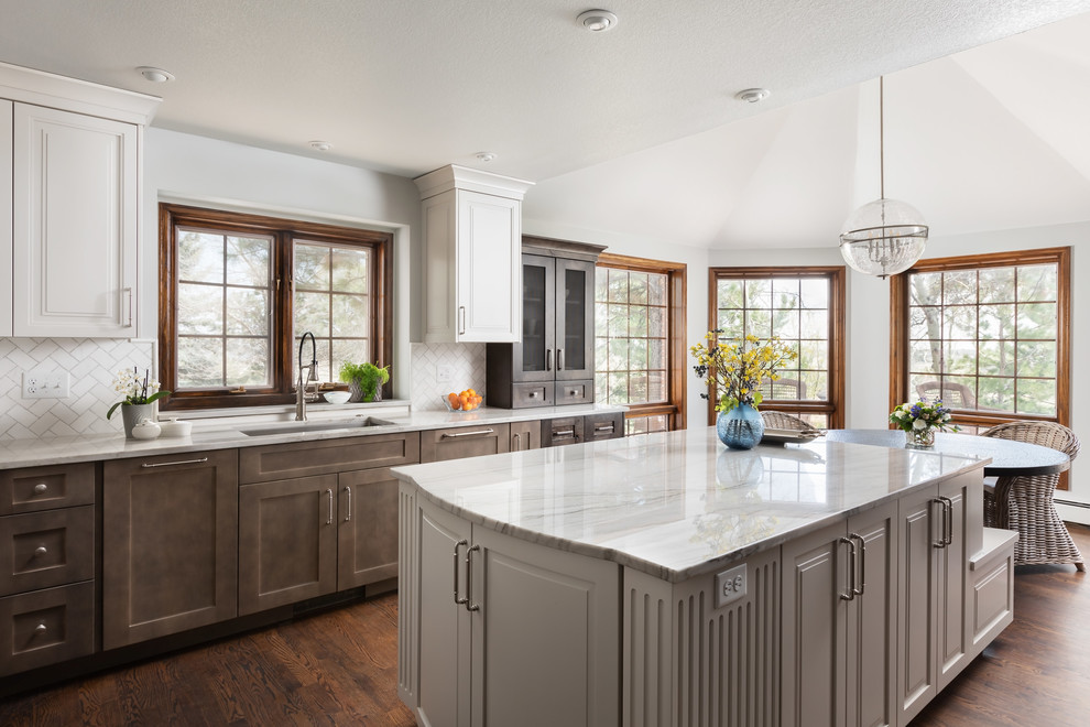 Transitional dark wood floor and brown floor kitchen photo with an undermount sink, shaker cabinets, dark wood cabinets, white backsplash, an island and white countertops