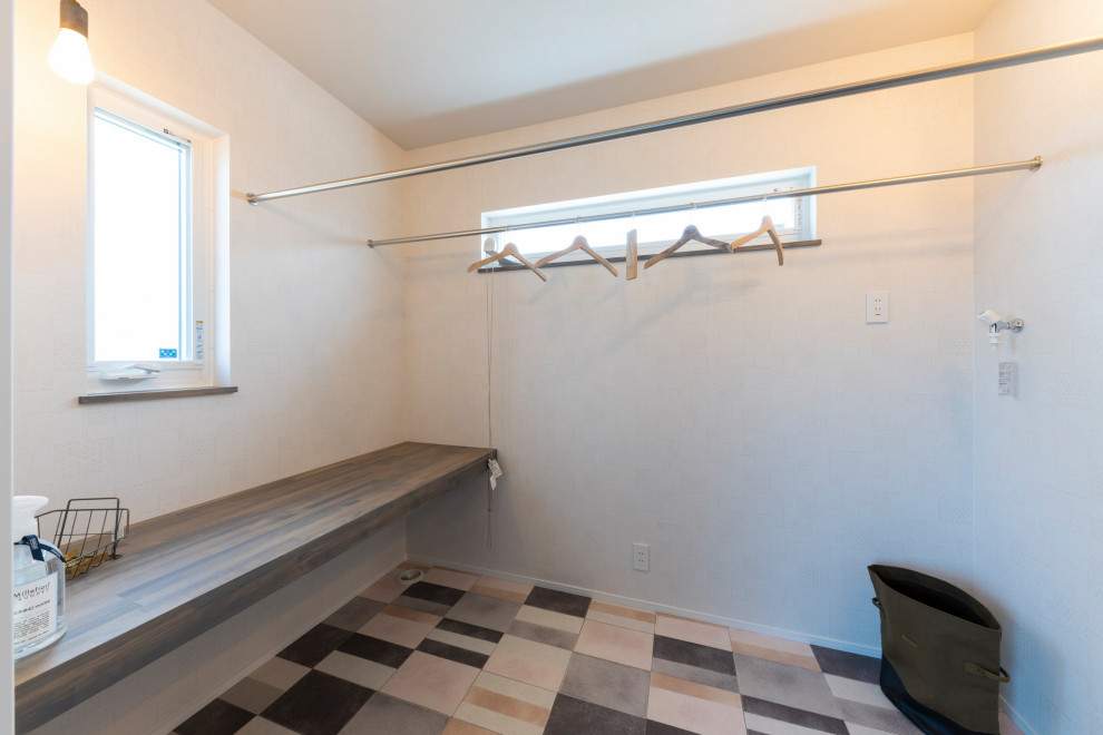 Minimalist laundry room photo in Other with white walls