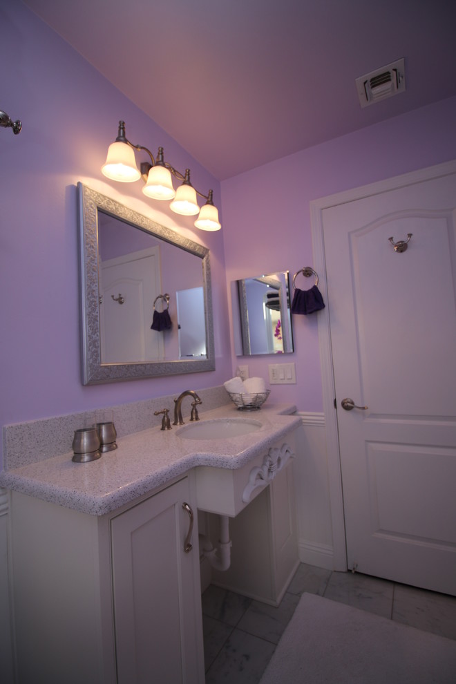 Photo of a mid-sized traditional 3/4 bathroom in Other with an undermount sink, beaded inset cabinets, white cabinets, engineered quartz benchtops, a claw-foot tub, a two-piece toilet, gray tile, stone tile, purple walls and marble floors.