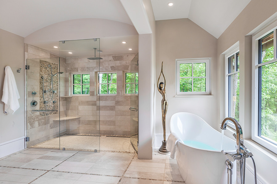 Large contemporary master bathroom in Other with flat-panel cabinets, dark wood cabinets, a freestanding tub, a curbless shower, beige tile, mosaic tile, beige walls, marble benchtops, marble floors, a vessel sink, beige floor and a hinged shower door.