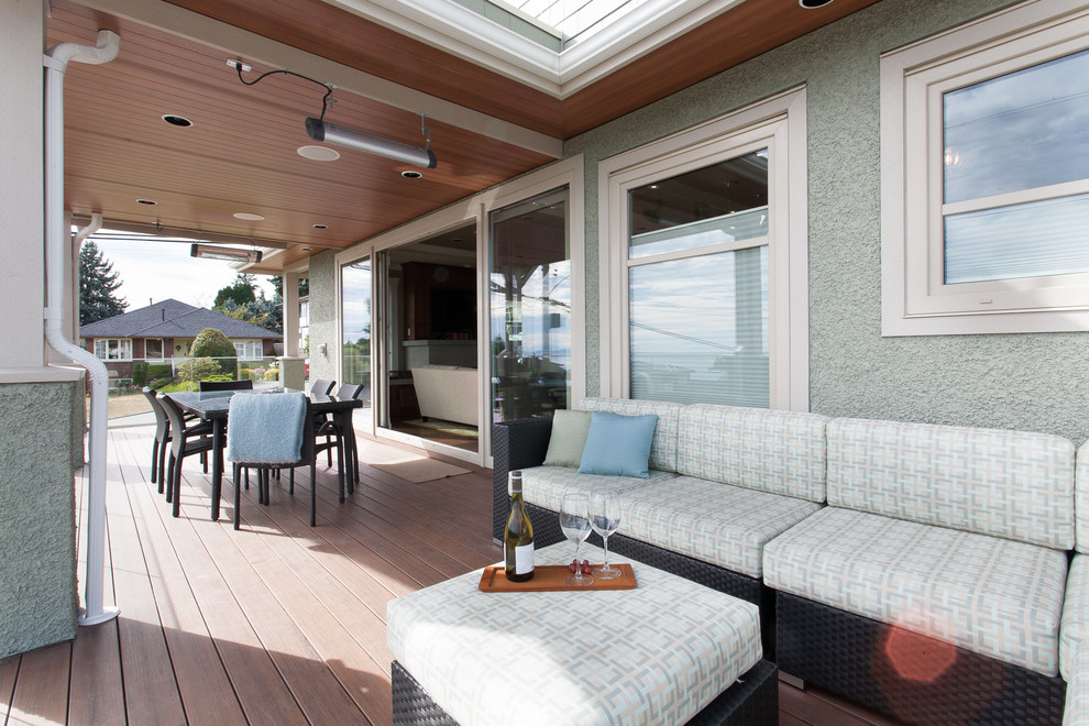 Large transitional deck in Vancouver with a roof extension.