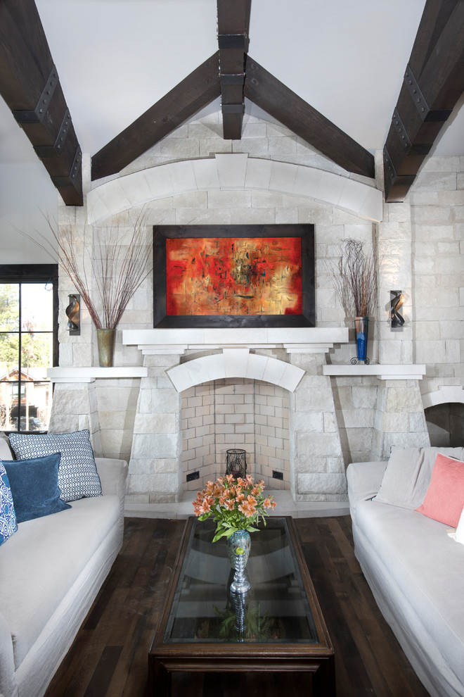 This is an example of a country formal living room in Denver with a standard fireplace and a stone fireplace surround.