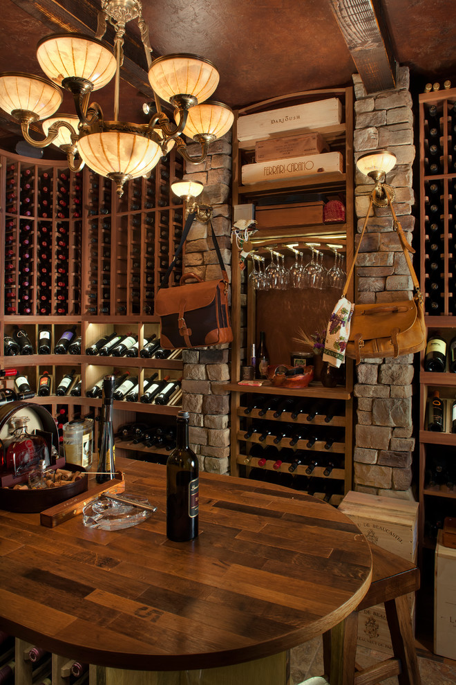 Photo of a mid-sized country wine cellar in Phoenix with storage racks, beige floor and slate floors.