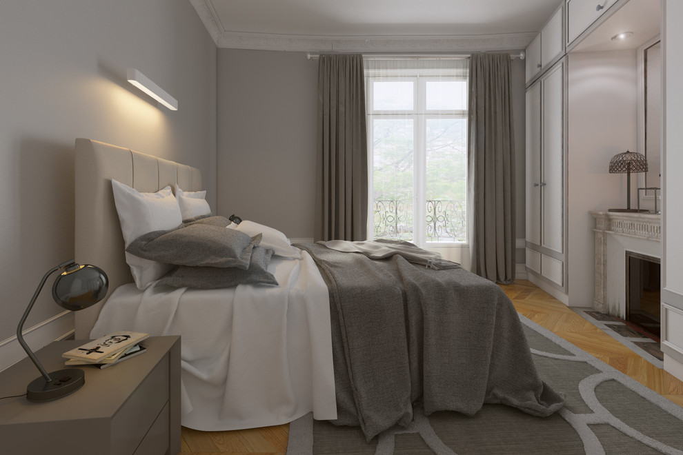 This is an example of a mid-sized transitional master bedroom in Paris with grey walls, a stone fireplace surround, light hardwood floors, beige floor, wood and wood walls.