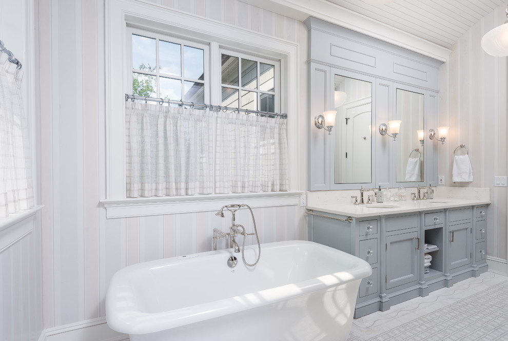 Design ideas for a mid-sized transitional 3/4 bathroom in Bridgeport with beaded inset cabinets, white cabinets, a freestanding tub, white tile, multi-coloured walls, porcelain floors, granite benchtops and white floor.