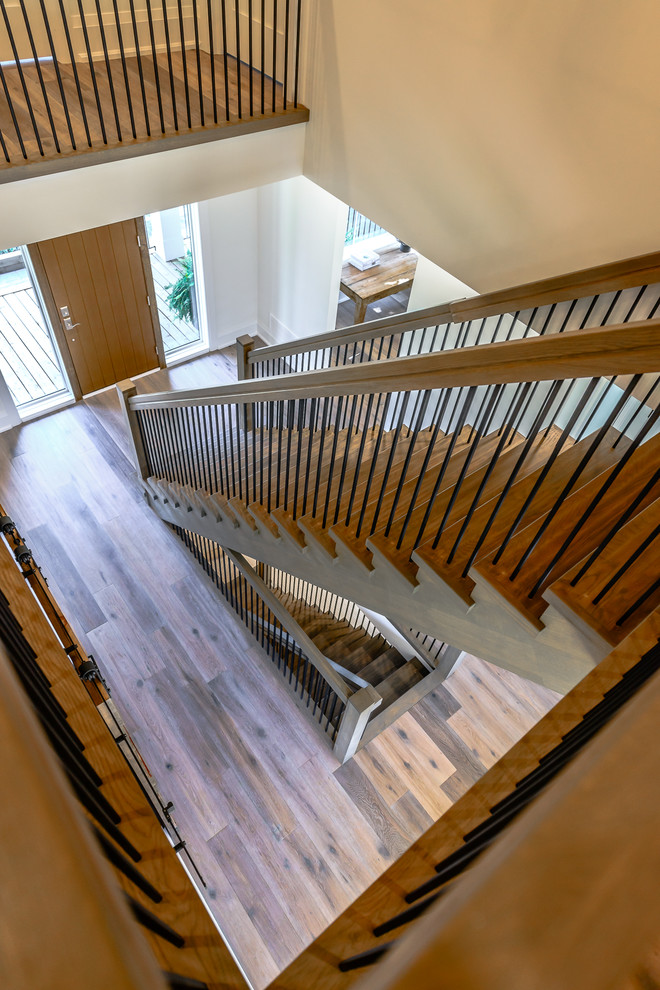 Entry hall - large transitional medium tone wood floor entry hall idea in Toronto with white walls and a medium wood front door