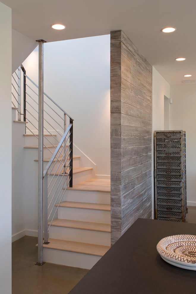 Photo of a mid-sized contemporary wood u-shaped staircase in Austin with painted wood risers.