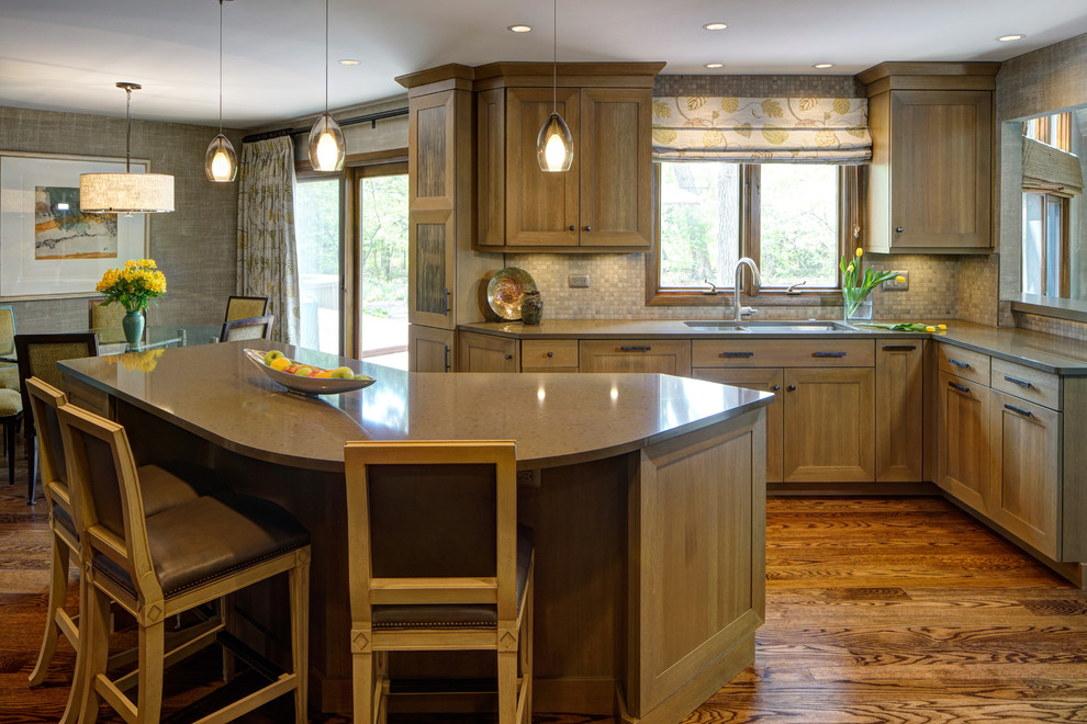 Eat-in kitchen - transitional medium tone wood floor eat-in kitchen idea in Chicago with a double-bowl sink, shaker cabinets, medium tone wood cabinets, quartz countertops, gray backsplash, stone tile backsplash, stainless steel appliances and an island