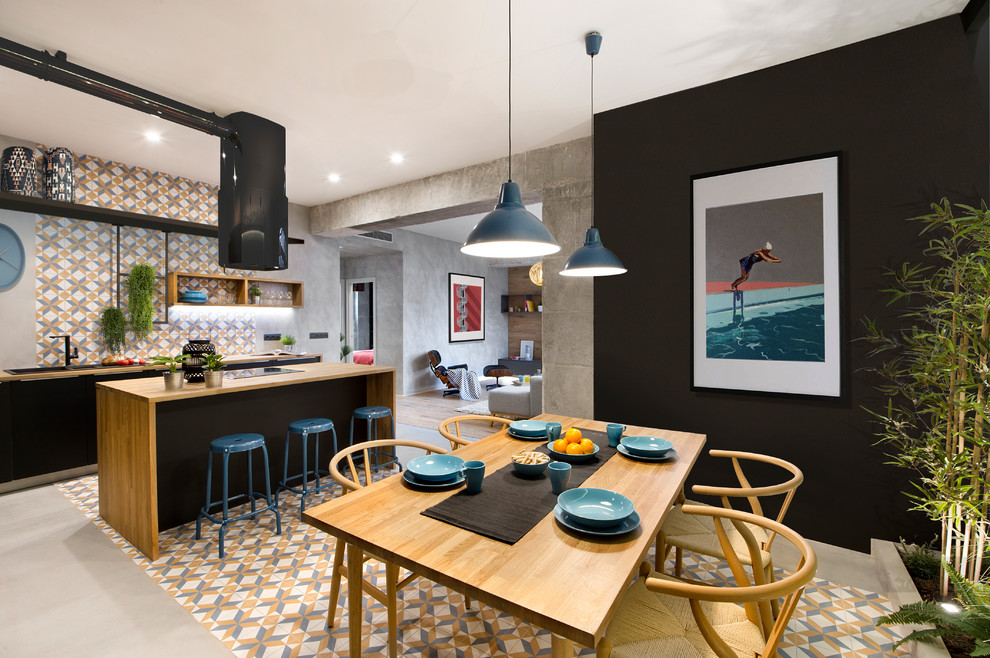 Inspiration for a mid-sized industrial kitchen/dining combo in Barcelona with multi-coloured floor and black walls.