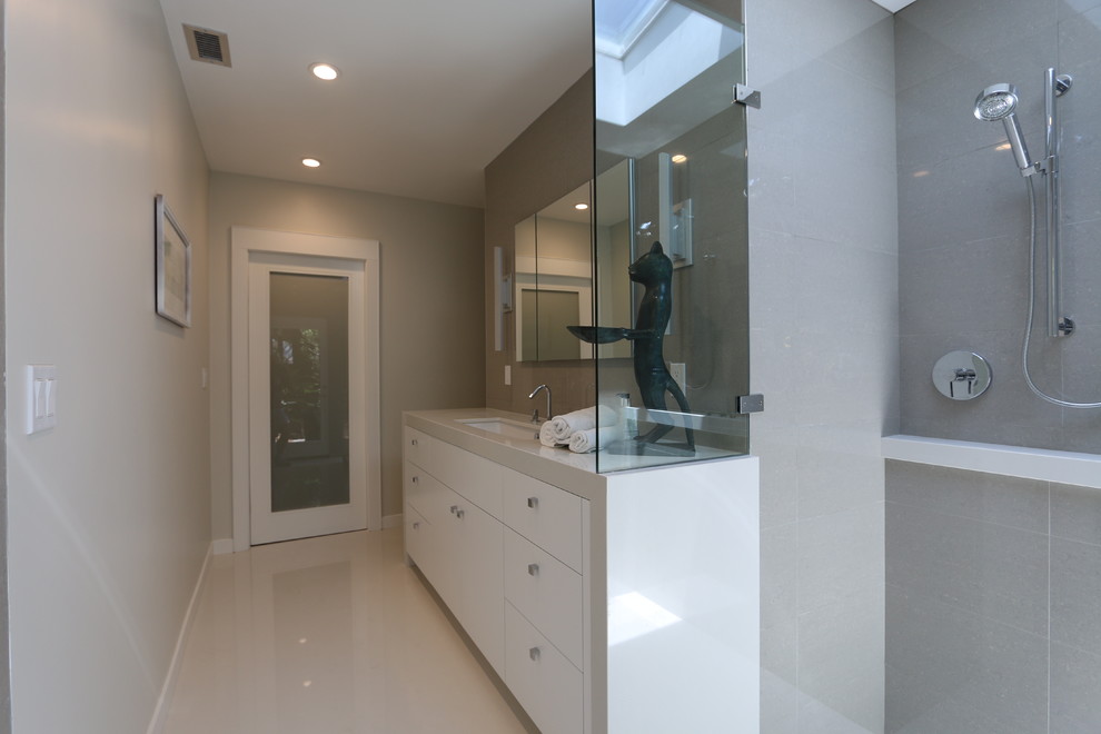 Design ideas for a mid-sized midcentury master bathroom in Orange County with flat-panel cabinets, white cabinets, quartzite benchtops, gray tile, a drop-in sink, a corner shower, ceramic tile, beige walls and ceramic floors.