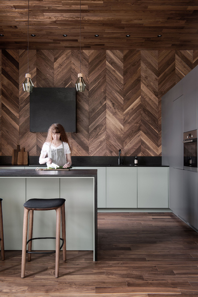 Photo of a contemporary kitchen in Saint Petersburg with wood benchtops, brown splashback, timber splashback, medium hardwood floors and brown benchtop.