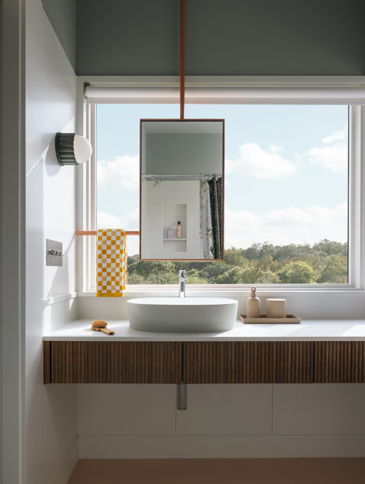 Inspiration for a contemporary bathroom in Austin with medium wood cabinets, grey walls, a vessel sink, orange floors, white worktops, a single sink and a floating vanity unit.