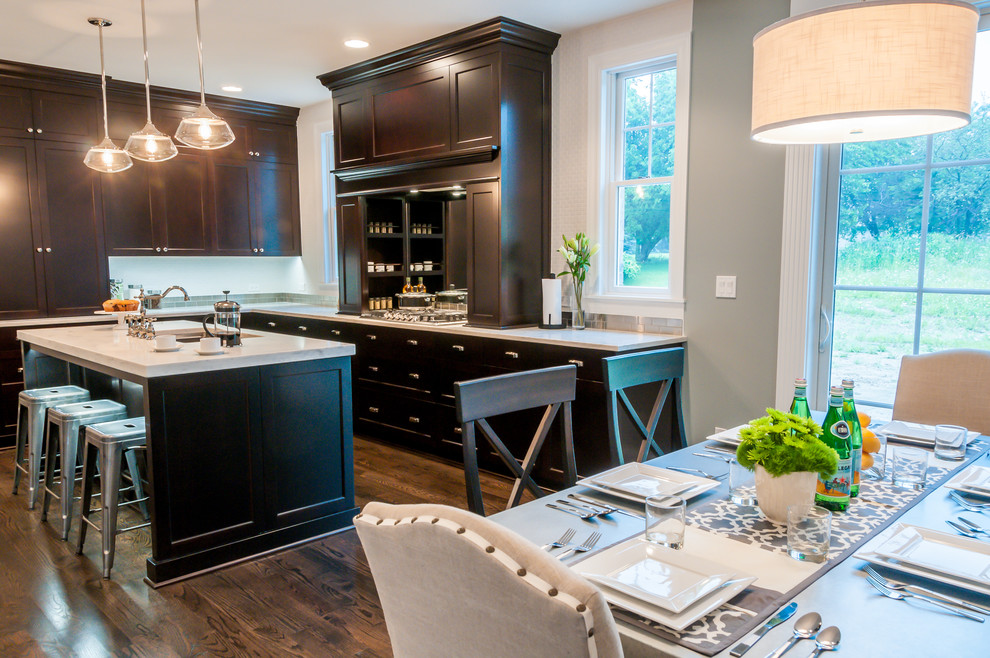 Eat-in kitchen - mid-sized transitional l-shaped dark wood floor eat-in kitchen idea in Chicago with an undermount sink, recessed-panel cabinets, dark wood cabinets, quartzite countertops, stainless steel appliances and an island