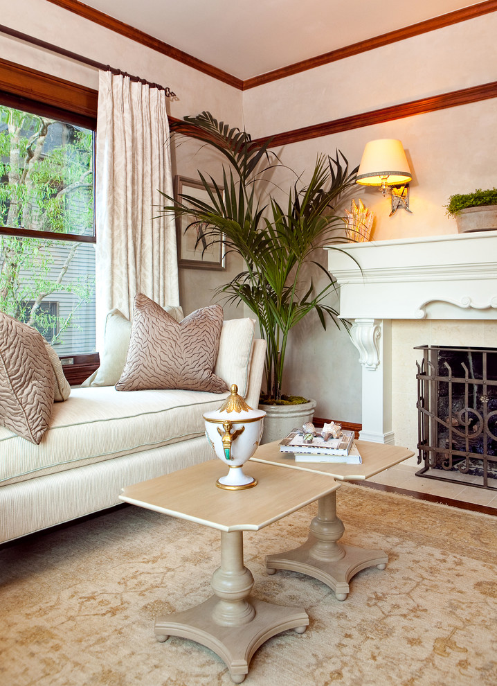 This is an example of a traditional living room in Portland with beige walls and a standard fireplace.