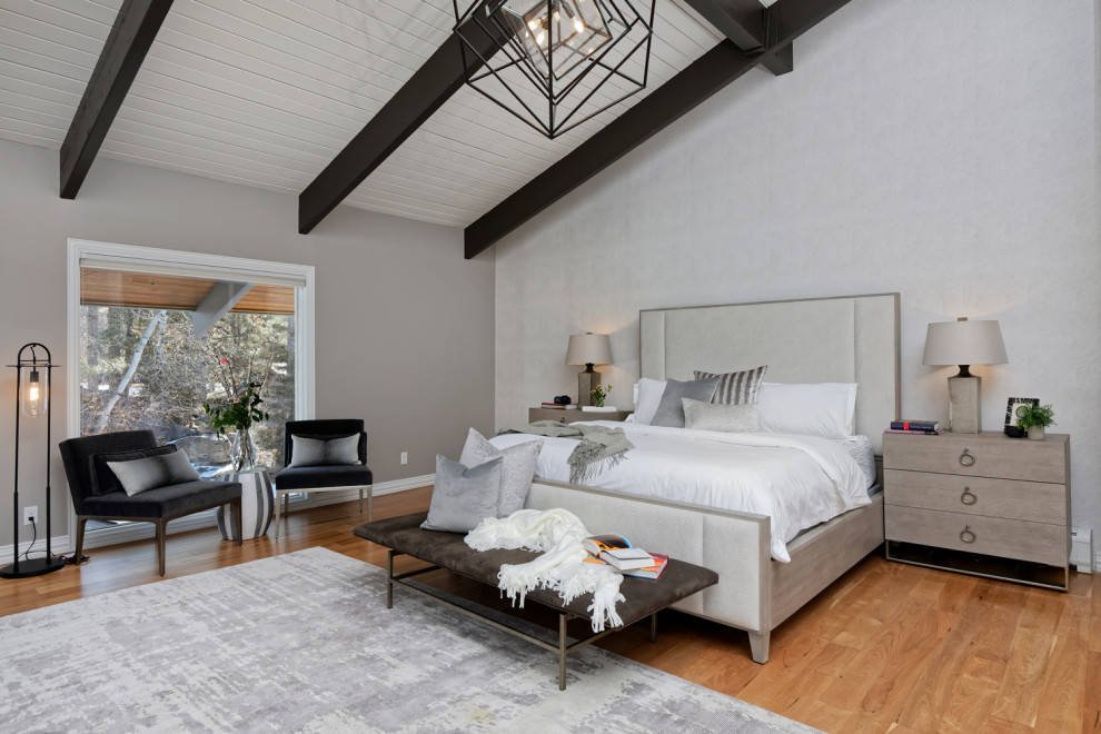Photo of a medium sized contemporary master bedroom in Santa Barbara with beige walls, medium hardwood flooring and no fireplace.