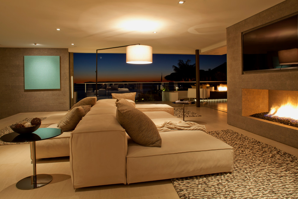 This is an example of an expansive contemporary open concept living room in Orange County with grey walls.