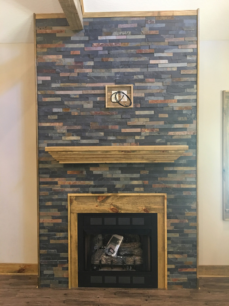 Living room - mid-sized rustic open concept dark wood floor and brown floor living room idea with beige walls, a standard fireplace and a stone fireplace